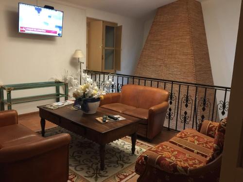 a living room with a couch and a table at Abetarda CC in São Marcos da Ataboeira