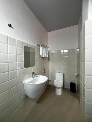 a bathroom with a sink and a toilet at The View Hotel Falkland in Āīzawl