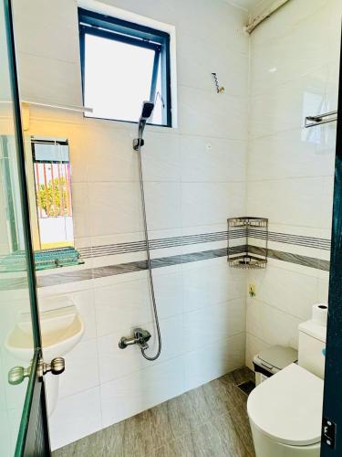 a bathroom with a shower and a toilet and a sink at Arden Villa Quy Nhơn in Quy Nhon