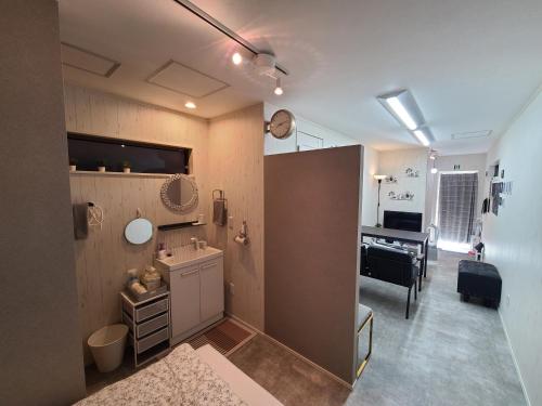 a room with a bathroom with a sink and a desk at Greci Art Tokyo グレーチアート東京 in Tokyo