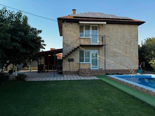 a house with a swimming pool in front of it at Дом с подогреваемым бассейном in Liski