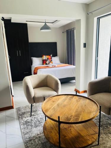 a living room with a bed and a coffee table at Xitshavani Lodge in Phalaborwa