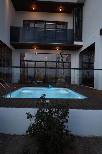 a house with a swimming pool in front of a building at إستراحة نمارق in Al ‘Aqar