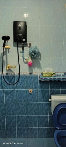 a bathroom with a toilet and a water hose at Hot Spring Residential B in Kuala Lumpur