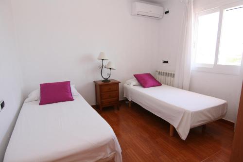 Tempat tidur dalam kamar di Villa Mara
