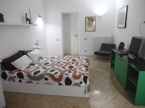 a bedroom with a bed and a television at Sant' Alfonso Maria de Liguori in Nola