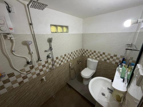a bathroom with a shower and a toilet and a sink at Fisherspot Villa in Weligama