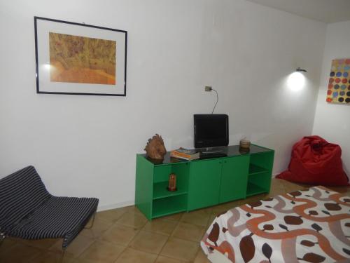 a bedroom with a green cabinet with a television on it at Sant' Alfonso Maria de Liguori in Nola