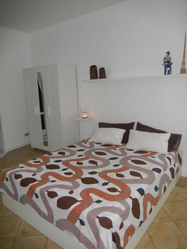 a bedroom with a bed with a brown and white comforter at Sant' Alfonso Maria de Liguori in Nola