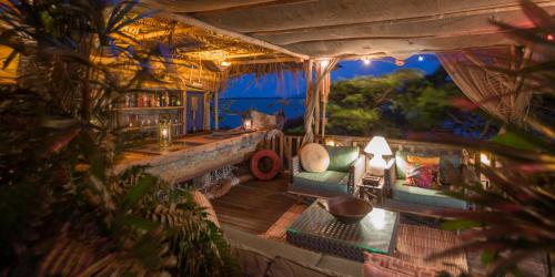 a view of a living room with a couch at Pousada Enseada das Garças in São Pedro da Aldeia