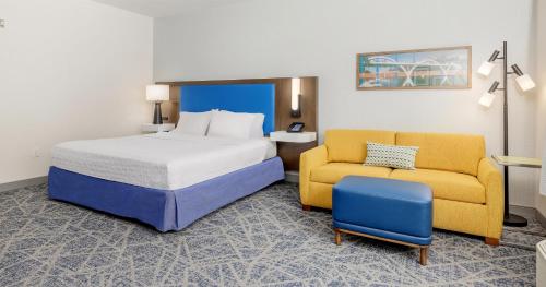 a hotel room with a bed and a chair at Hampton Inn & Suites Grants Pass in Grants Pass