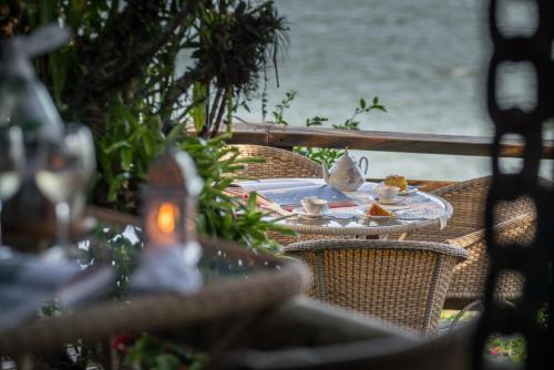 an outdoor table with a plate of food on it at Pousada Enseada das Garças in São Pedro da Aldeia