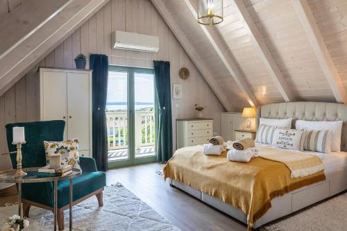 a bedroom with a large bed with towels on it at Lovassy Lodge Vendégház in Lovas