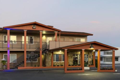a large apartment building with a staircase in front at Travelodge by Wyndham Eureka in Eureka