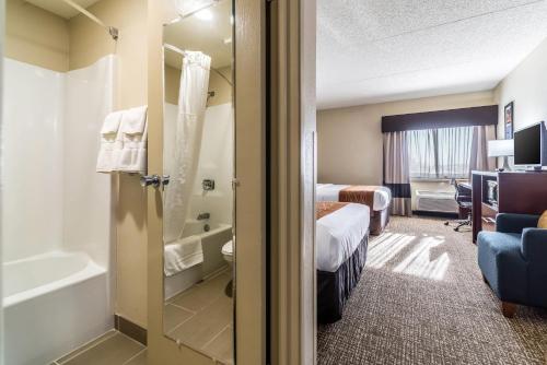 a hotel room with a bed and a bathroom at Comfort Inn Festus-St Louis South in Festus