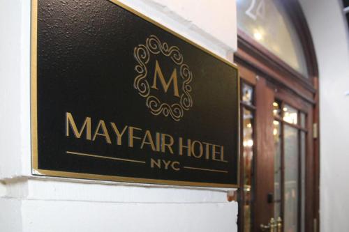 a sign for a mayfair hotel on the side of a building at The Mayfair Hotel Times Square, an Ascend Collection in New York