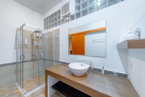 a bathroom with a sink and a shower at Taratai Villa Guest House in Nong Prue