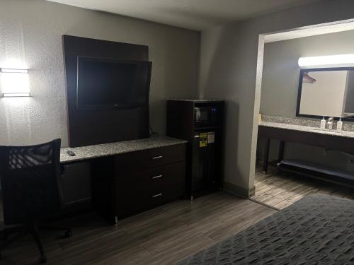 a room with a desk with a computer and a mirror at Western Inn Marietta in Atlanta