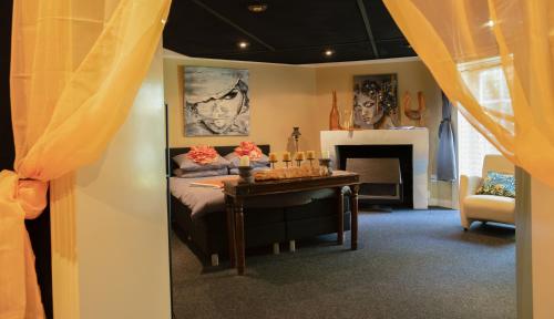 a bedroom with a bed and a table with candles at Pakhuis Bed and Breakfast Unique in Enschede