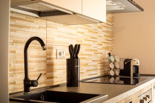 a kitchen with a sink and a counter top at Casa del Vicolo in Alghero