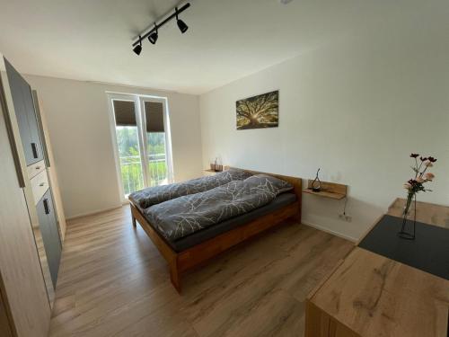a bedroom with a bed and a large window at Bei Kleins in Nümbrecht