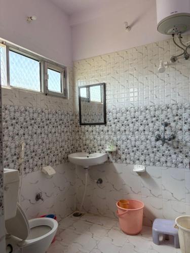 a bathroom with a sink and a toilet and a sink at BOBY HOME STAY "BOBY MANSION" Jaipur in Jaipur