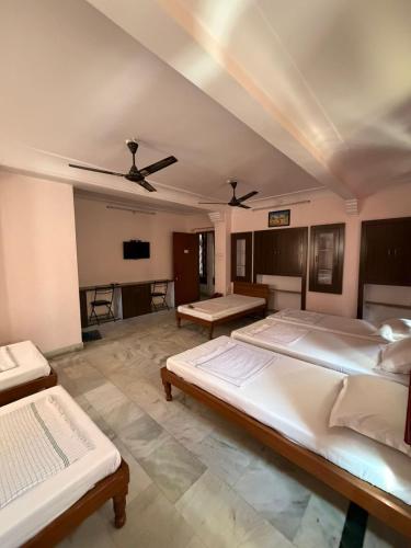 a large bedroom with two beds and a ceiling at BOBY HOME STAY "BOBY MANSION" Jaipur in Jaipur