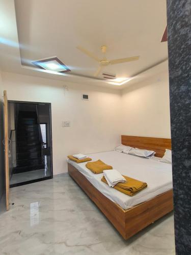 a bed in a room with a ceiling at HOTEL Shiv Sai in Shirdi