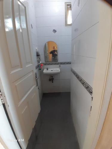 a small bathroom with a sink and a mirror at Villa Dinar Mountain Estate in Lembang