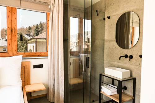 a bathroom with a shower and a sink and a mirror at Wierzbowa16 in Szczyrk