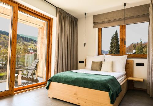 a bedroom with a bed and a large window at Wierzbowa16 in Szczyrk