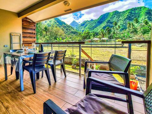 a porch with a table and chairs on a balcony at Teahupo'o Lodge Tahiti - Studio Moana, lagon et quai en face - Canoës inclus in Teahupoo