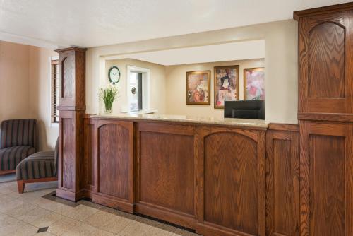 a lobby with a wooden bar with a television at The Inn at Market Square in San Antonio