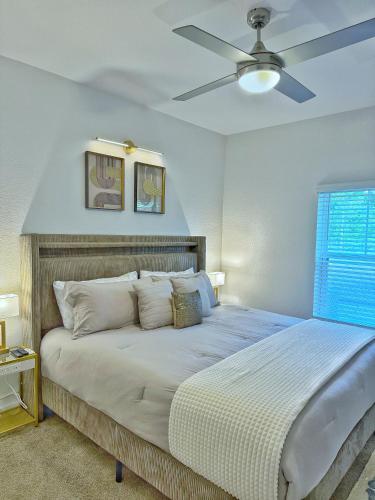 a bedroom with a bed with a ceiling fan at Beachline Oasis in Jacksonville