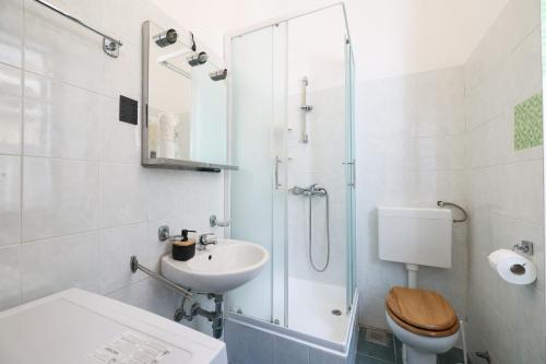 a bathroom with a toilet and a sink and a shower at Apartment Poluotok in Zadar