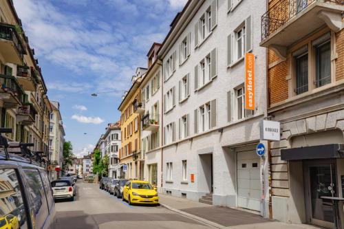 a yellow car parked on a street next to a building at easyHotel Zürich City Centre in Zurich