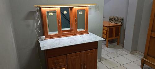 a bathroom with a sink and a mirror at Malan's Siësta 2 in Kimberley