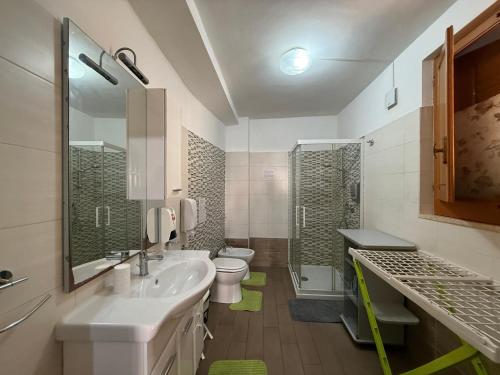 a bathroom with a sink and a toilet and a shower at LightHouse - Casa di Luce in Reggio di Calabria