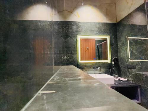 a bathroom with a sink and a mirror at City Center Suites in Bhatinda
