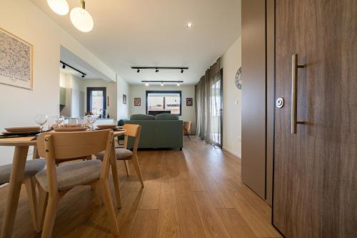 a dining room and living room with a table and chairs at New Amazing 2 bedroom flat near casino beach mall in Limassol