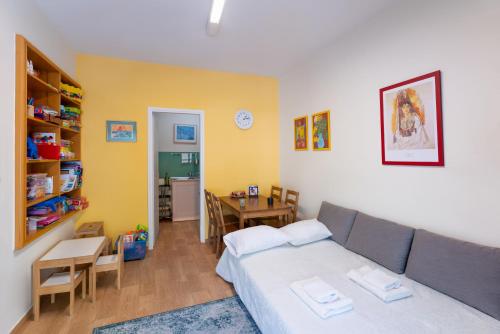 a living room with a bed and a dining room at Folitsa happy central home in Rhodes Town