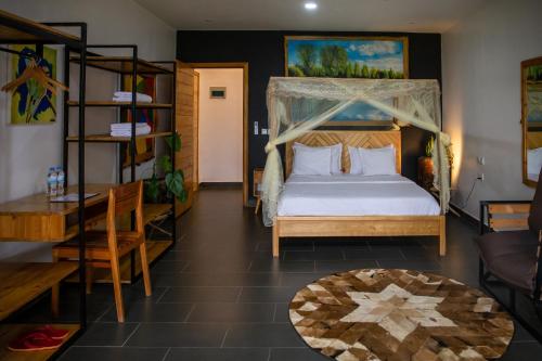 a bedroom with a bed with a canopy at Eagle View Lodge - Kigali in Kigali