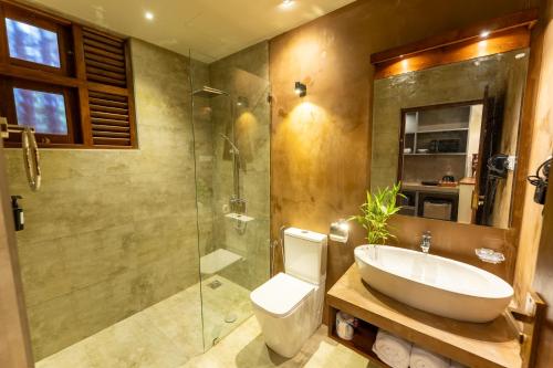 a bathroom with a toilet and a sink and a shower at Aqualuna Weligama in Weligama