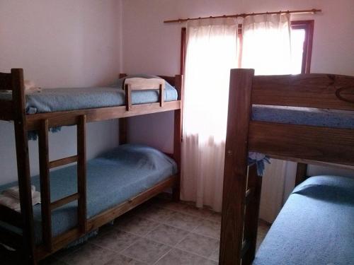 En eller flere senge i et værelse på Complejo Playa Grande