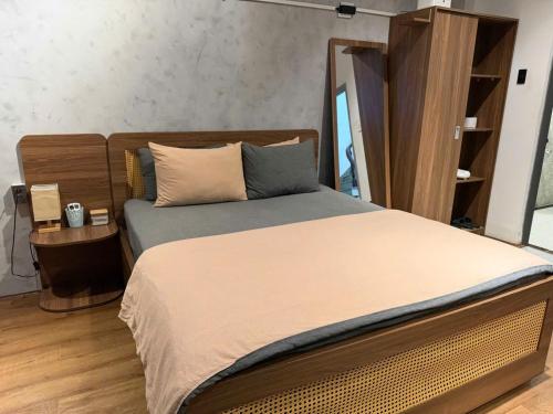 a bedroom with a large bed with a wooden headboard at Choco village 126A in Xã Thang Tam