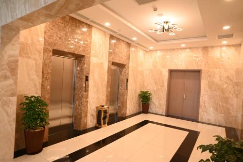 a lobby with marble walls and a elevator at Sai Gon Da Lat Premium in Da Lat