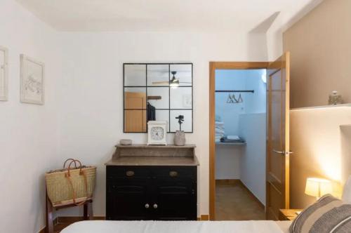 a bedroom with a mirror and a black dresser at B&B Casa Mil Sueños in Ontinyent