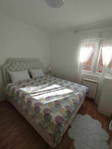 a bedroom with a bed with a quilt on it at DežaVu in Ledine
