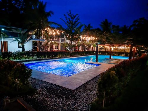 a swimming pool in front of a house at night at Severina Lodge in San Juan
