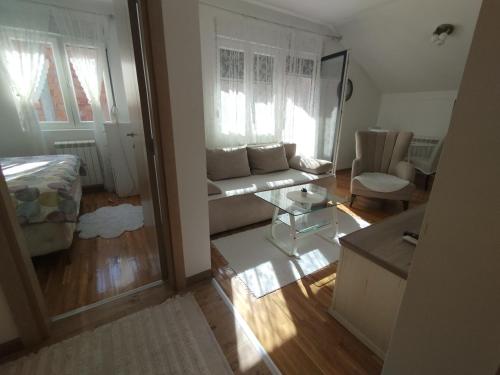 a living room with a couch and a table at DežaVu in Ledine